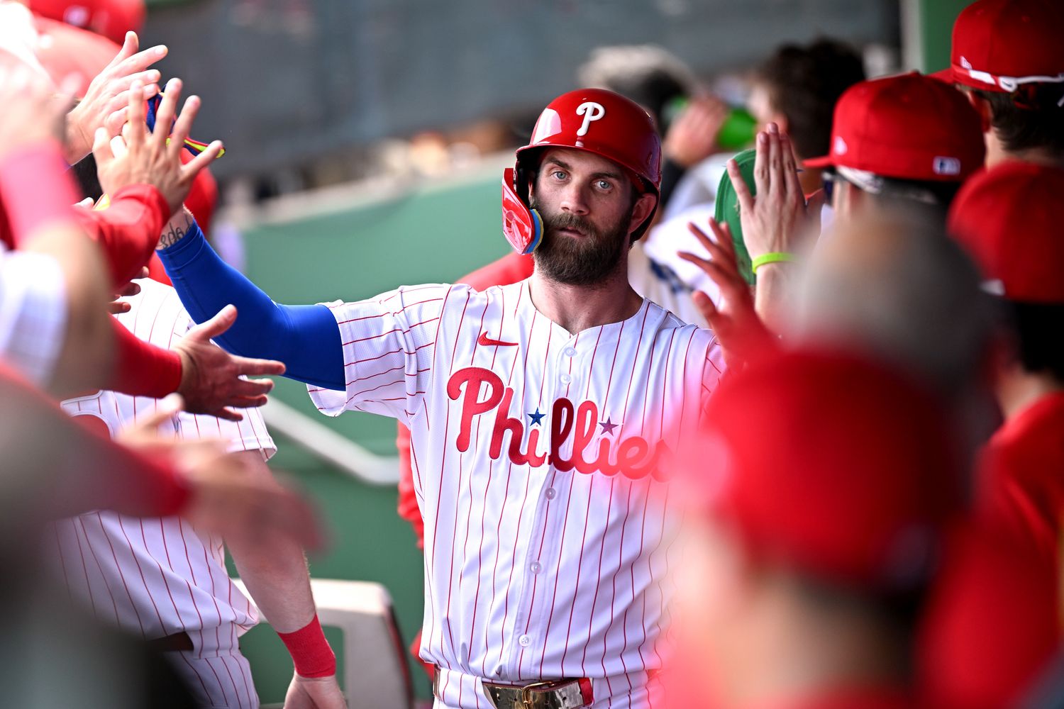 Mar 8, 2024; Clearwater, Florida, USA; Philadelphia Phillies first baseman Bryce Harper (3) celebrates with his teammates after scoring a run in the first inning of the spring training game against the Houston Astros at BayCare Ballpark.